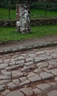 Stele of a naked youth in front of an antique pavement
