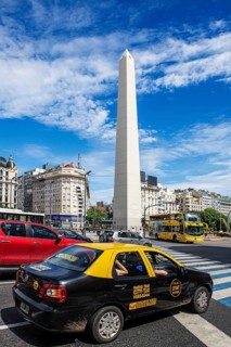 Obelisk and taxi at the Plaza de la Republica, Avenida 9 de Julio, Buenos Aires, Argentina, South