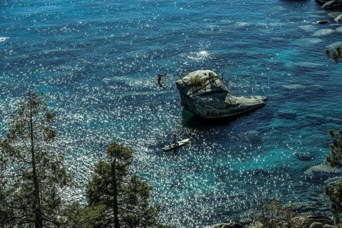 Standup paddler at Bonsai Rock, Sapphire Cove, Lake Tahoe, Nevada, USA, North America