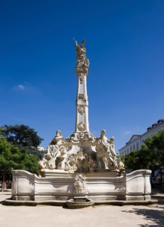 Rococo fountain with depictions of the four seasons and St George as dragon slayer on obelisk,