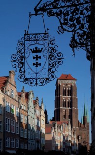 West view through Jopengasse with town houses, wrought-iron hanger with Gdansk coat of arms at the