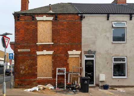 Derelict empty boarded-up house next to renovated house, Willingham Terrace, Grimsby, north east
