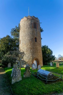 Detached round tower of village parish church of Saint Andrew, Bramfield, Suffolk, England, UK