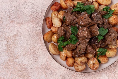 Kuyrdak, roast offal with potatoes and fresh herbs, homemade in Kazakh, no people