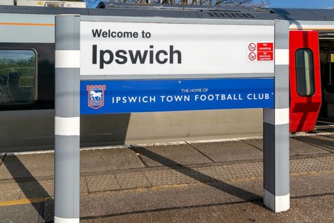 Welcome to Ipswich sign, home of Ipswich Town Football Club, platform of railway station, Ipswich,