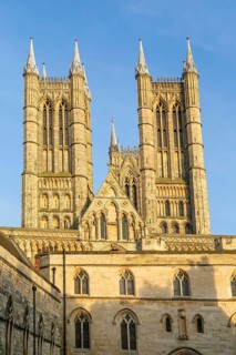 Towers of cathedral church rise above the medieval Exchequer Gate, Lincoln, Lincolnshire, England,