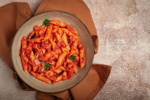 Penne pasta, with shrimp in tomato sauce, close-up, no people