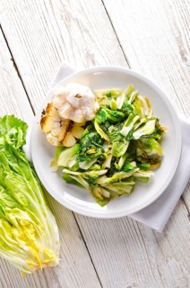 Baked Romaine lettuce with garlic and pine cores
