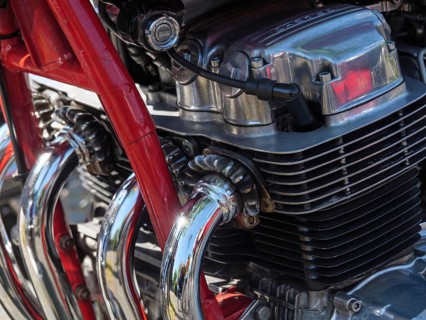 Close-up of a motorbike with red painted frame and chromed cylinder heads, Appelhülsen,