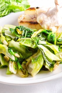 Baked Romaine lettuce with garlic and pine cores