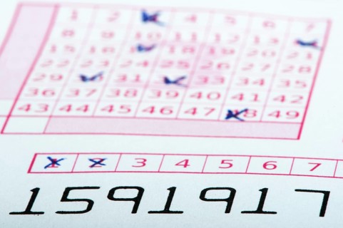Marked lottery ticket close up. Studio shot