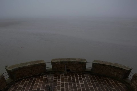 Mont-Saint-Michel, monastery mountain, view from the Tour Cholet into the mudflats in foggy weather