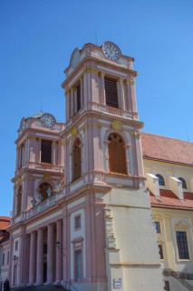 Baroque church with striking pink towers and blue sky, wachaus, donau, austria