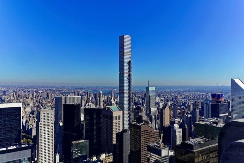 Rockefeller Center observation deck, Modern skyscrapers towering under a bright blue sky above the