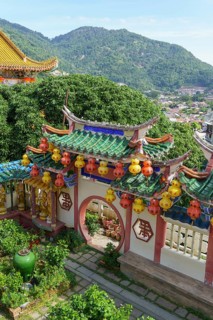 Colourful entrance gate with decorative lanterns and green surroundings, penang, malaysia