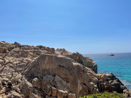 Rocky coast with a view of the blue sea as far as the horizon under a clear sky, cagliari,