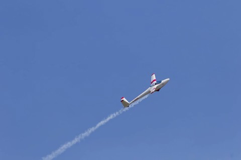 Airshow, glider with contrails against blue sky, Montreal, Province of Quebec, Canada, North