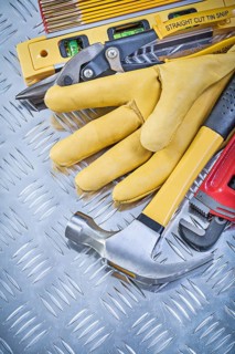 Composition of claw hammer leather safety gloves construction level wooden meter pliers pipe wrench