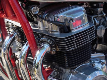 Detailed view of a chromed motorbike engine with red frame and cylinders in focus, Appelhülsen,