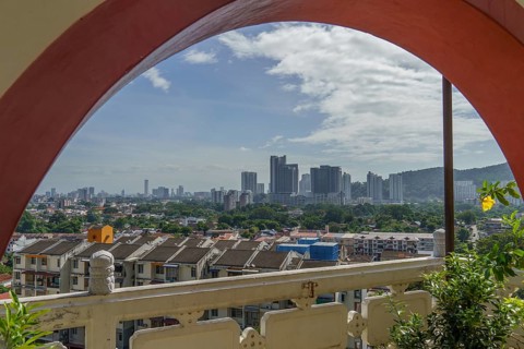View through an arch onto a modern cityscape, penang, malaysia