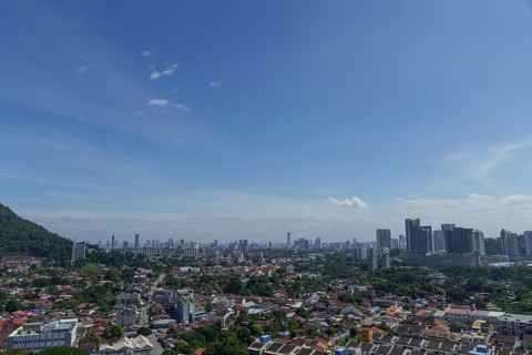 Big city under a clear blue sky with scattered clouds, penang, malaysia