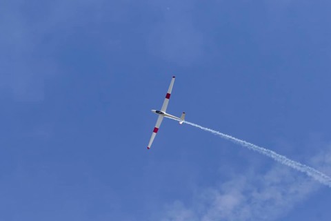Airshow, glider with contrails against blue sky, Montreal, Province of Quebec, Canada, North
