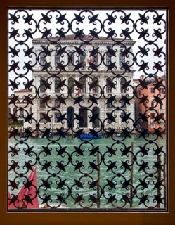 Venice, Ca'Grande (Palazzo Corner) on the Grand Canal seen through a barred window of the Peggy
