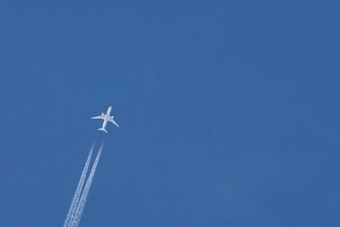 Boeing 787-8 Dreamliner jet passenger aircraft of Aeromexico flying in a blue sky with a vapor