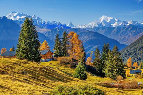 Autumn landscape with chalets and panorama of Dom 4545m, Matterhorn 4478m and Weisshorn 4505m,