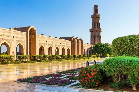 Side wing with minaret and flower-decorated courtyard of the Sultan Qaboos Mosque, Muscat, Arabian