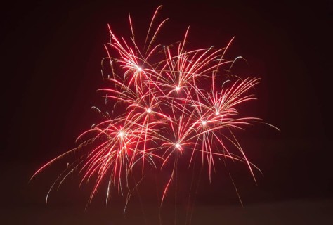 Red fireworks glow in vivid trails of light in the dark, Lower Saxony, Germany, Europe