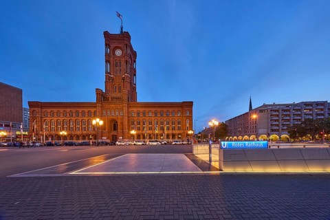 Red Town Hall with underground station and lanterns at dusk, Rathausstraße, Berlin, capital city,