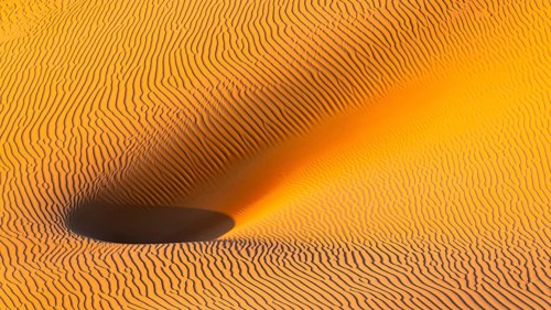 Wind-sculpted sand structure in the Rub al Khali desert, Dhofar province, Arabian Peninsula,