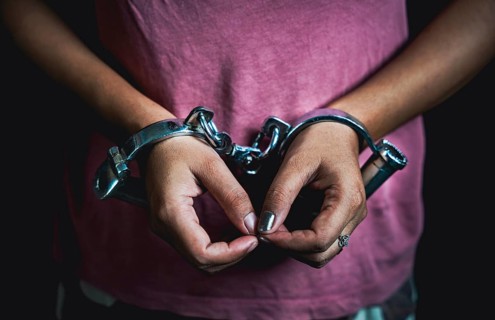 Woman hands in handcuffs- concept image