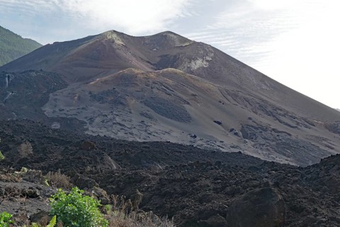 Imposing volcano with dark ash slopes and rocky terrain, last volcanic eruption of Cumbre Vieja,