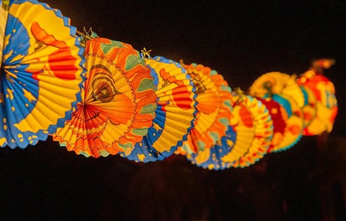 Lanterns attached to a rope during a lantern procession, paper, custom, moon, stars, sky, light,