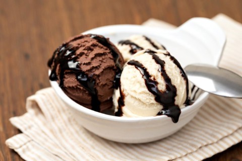 Bowl with tasty ice cream on table