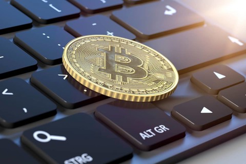 3d rendering of a bitcoin coin on a keyboard