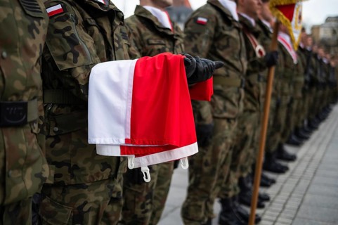 The Polish flag held by a soldier during the ceremony. Poland