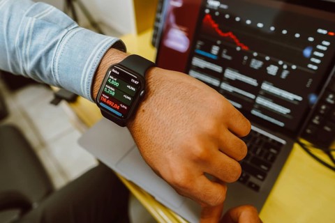 In this photo, man checking the stock price on the stock exchange through his Apple Watch