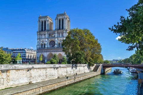 Notre-Dame de Paris is a medieval Catholic cathedral in Paris. View of cathedral facade from Seine