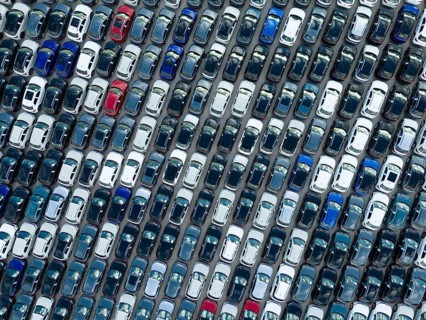 New Cars on Large Parking Lot in Port Ready for Distribution to Dealer. Automobile Industry