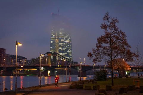 Low clouds envelop the illuminated European Central Bank (ECB) in Frankfurt am Main in the evening.