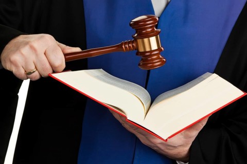 A judge with a law book in court. Gavel in hand, A judge with a law book in court. Gavel in hand.