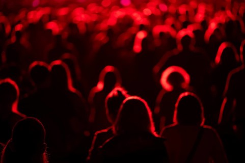 Crowd of people in front of the stage during the concert.