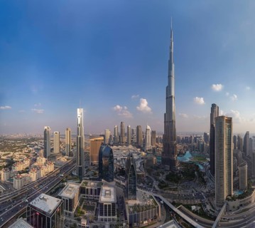 A picture of the Burj Khalifa towering the buildings of the nearby Downtown Dubai, Business Bay and