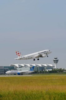 Brussels Airlines A319 taking off on Runway North with United Airlines, control tower and Terminal