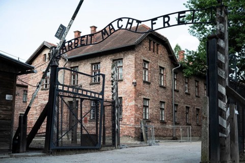 The main gate to the concentration camp Auschwitz Birkenau with an inscription in German Arbeit