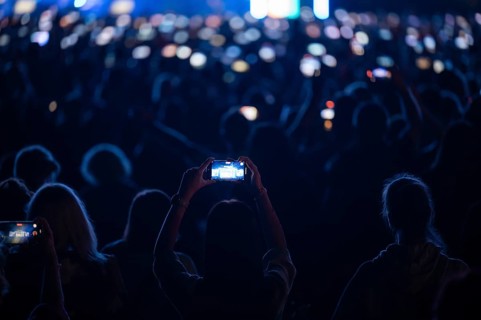 Crowd of people in front of the stage during the concert.