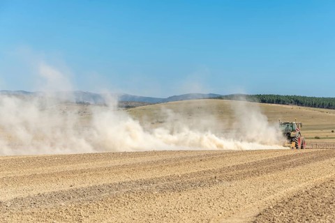 Dust cloud lifted by tractor in times of drought. Cevennes, massif central, France, Europe